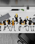 Anime desk pad 40x20 inches in bold black and orange, sharp ink strokes, dramatic yet tidy vibe.