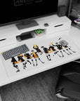 Hinata jumping with Kageyama beside him on Haikyuu desk pad 36x16 inches, in black jackets and orange shorts.