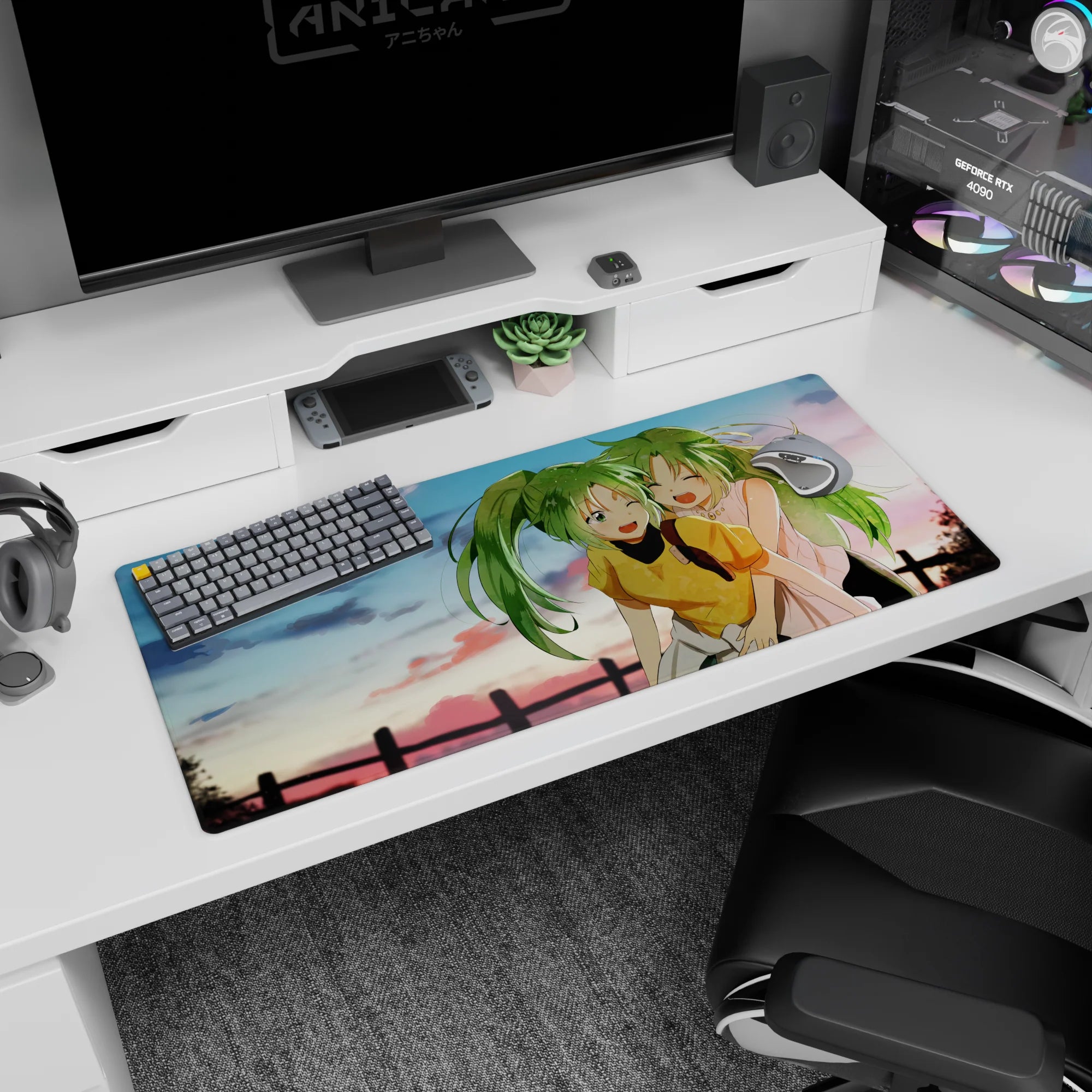 Two ponytailed green-haired anime girls giggling at sunset on a 36x16 inches desk pad by a fence.