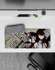 Auburn hair, blue eyes, beige backdrop, and black splatter chaos on an anime mouse pad 28x12 inches.