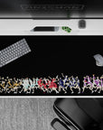 Vibrant orange, teal, red, blue and purple volleyball anime desk pad on black, 40x20 inches.