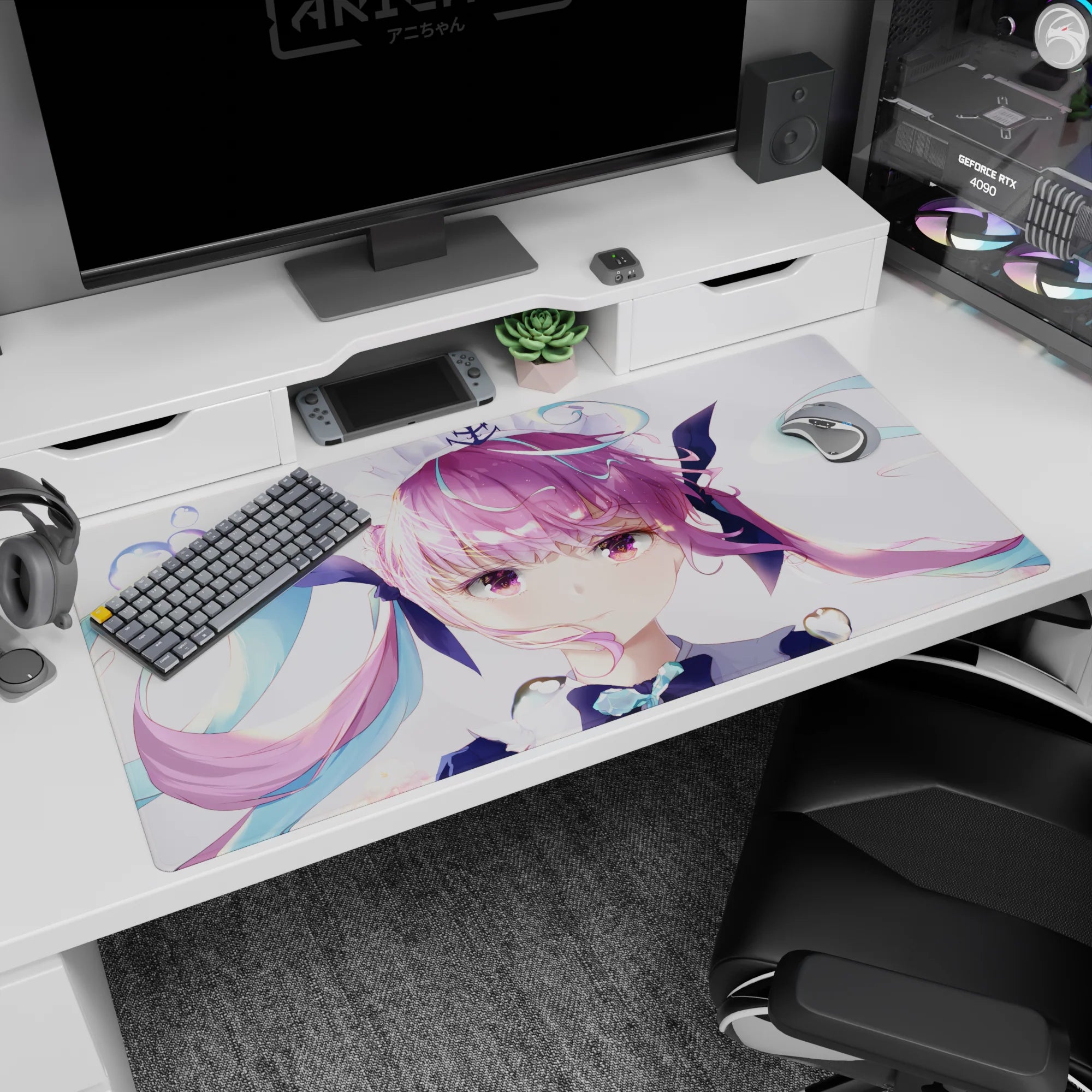Close-up pouty anime idol girl on desk pad 40x20 inches, pink twin-tails with teal ribbon accents.