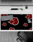 Villain-core Naruto desk mat in deep black and crimson red, bold Akatsuki clouds, 32x16 inches.
