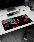Naruto Akatsuki cloak-inspired scene with marching red cloud emblems on black, 32x16 inches.