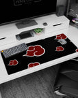 Naruto Akatsuki banner-style scene desk pad, 36x16 inches, red cloud emblems marching on black.