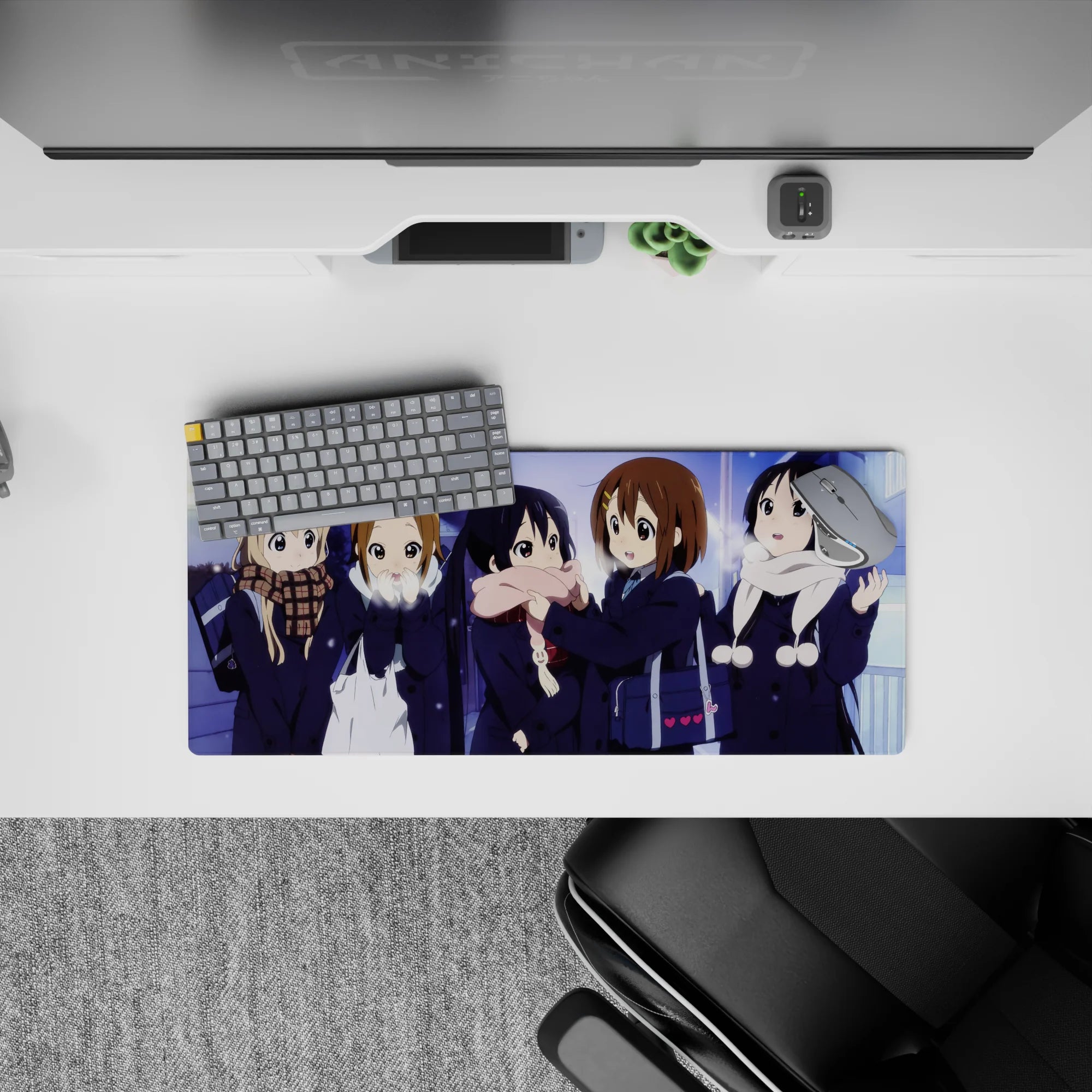 Cozy snowy night anime girl mouse pad 28x12 inches in soft blues and violet glow with cream and pink scarves.