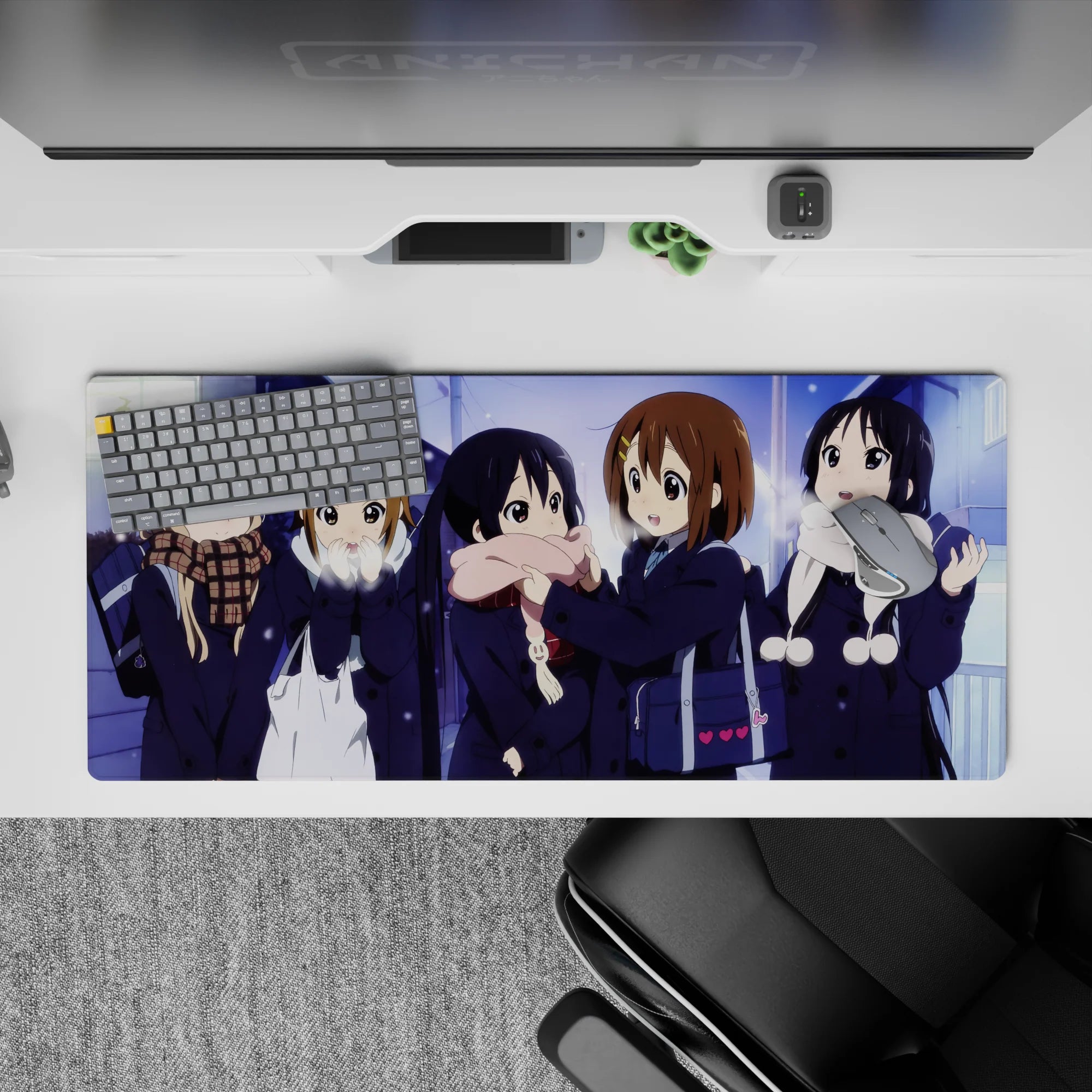 Cozy snowy night anime desk pad 36x16 inches in soft blues and violet glow with bright scarves.