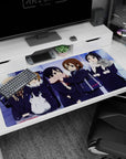 Yui Hirasawa and friends giggling on a snowy walk anime girl desk pad 40x20 inches, heart bag detail.