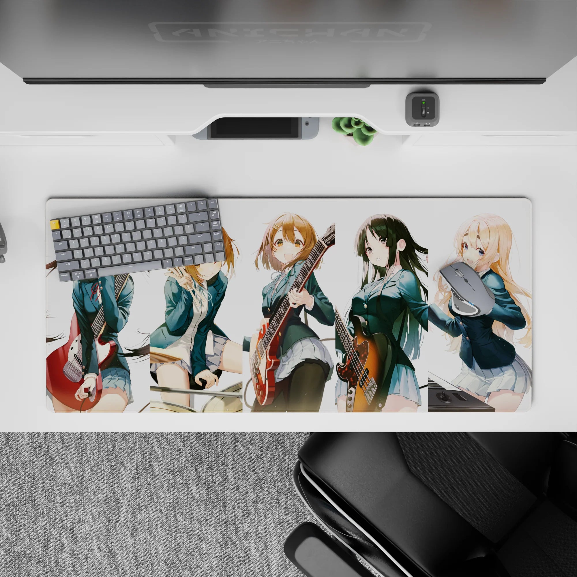 Cheerful teal blazers and warm guitar reds on a cozy anime girl desk pad 36x16 inches.