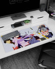 Hitagi Senjougahara with Araragi and Hachikuji anime girl desk pad 36x16 inches amid pencils.