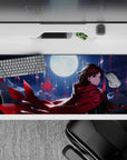 Moody 36x16 inches anime desk pad in deep blues and inky clouds, vivid crimson petals, glossy shine.
