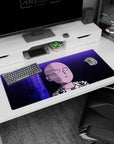 36x16 inches anime desk pad showing Saitama staring ahead, bald head and cape clasp lit in violet neon.