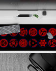 Dark crimson Sharingan eyes with sharp black tomoe and glowing blue rims, 36x16 inches anime desk pad.