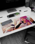 Teasing winged anime girl desk pad 36x16 inches, sideways lounge, finger to lips, white suit navy accents.