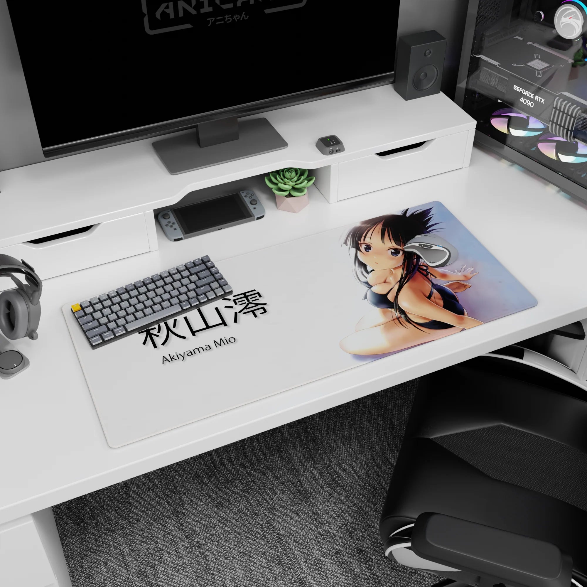 36x16 inches Akiyama Mio desk pad, seated in black bikini with over-the-shoulder shy glance and ribboned hair.