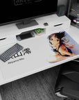 Akiyama Mio 40x20 inches desk pad, seated in black bikini with over-shoulder glance and ribboned hair.