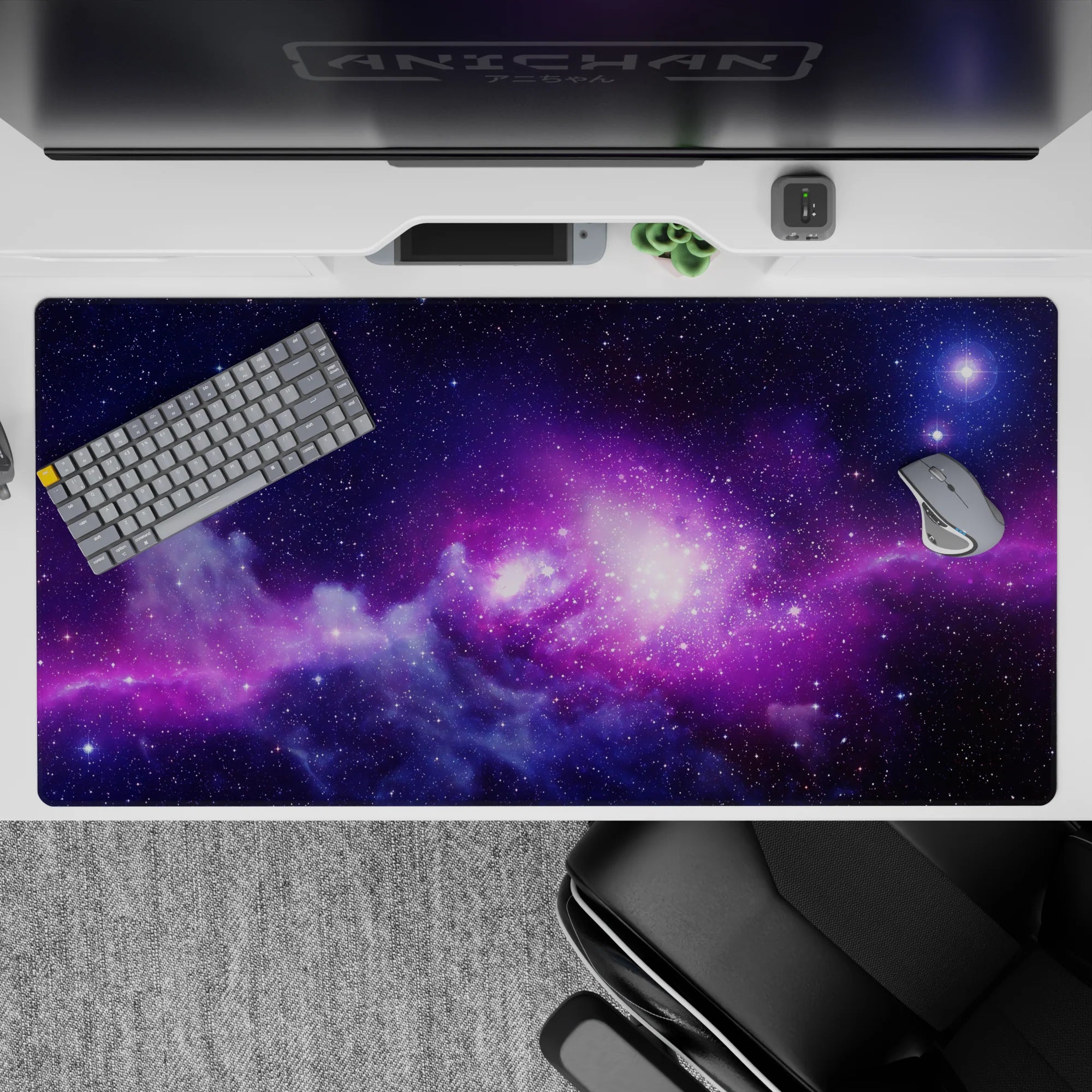 Dreamy 40x20 inches desk pad in deep indigo and glowing violet with warm pink light and scattered stars.