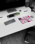 Winking pale-haired anime girl with ribbons on a 14x10 inches mouse pad, candy-toned desk scene.