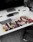 36x16 inches anime girl desk pad showing four blushing students packed together, wide-eyed over a hot bowl.