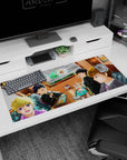 36x16 inches anime desk pad showing four friends in a booth, big-eyed smiles, messy hair, food doodles.