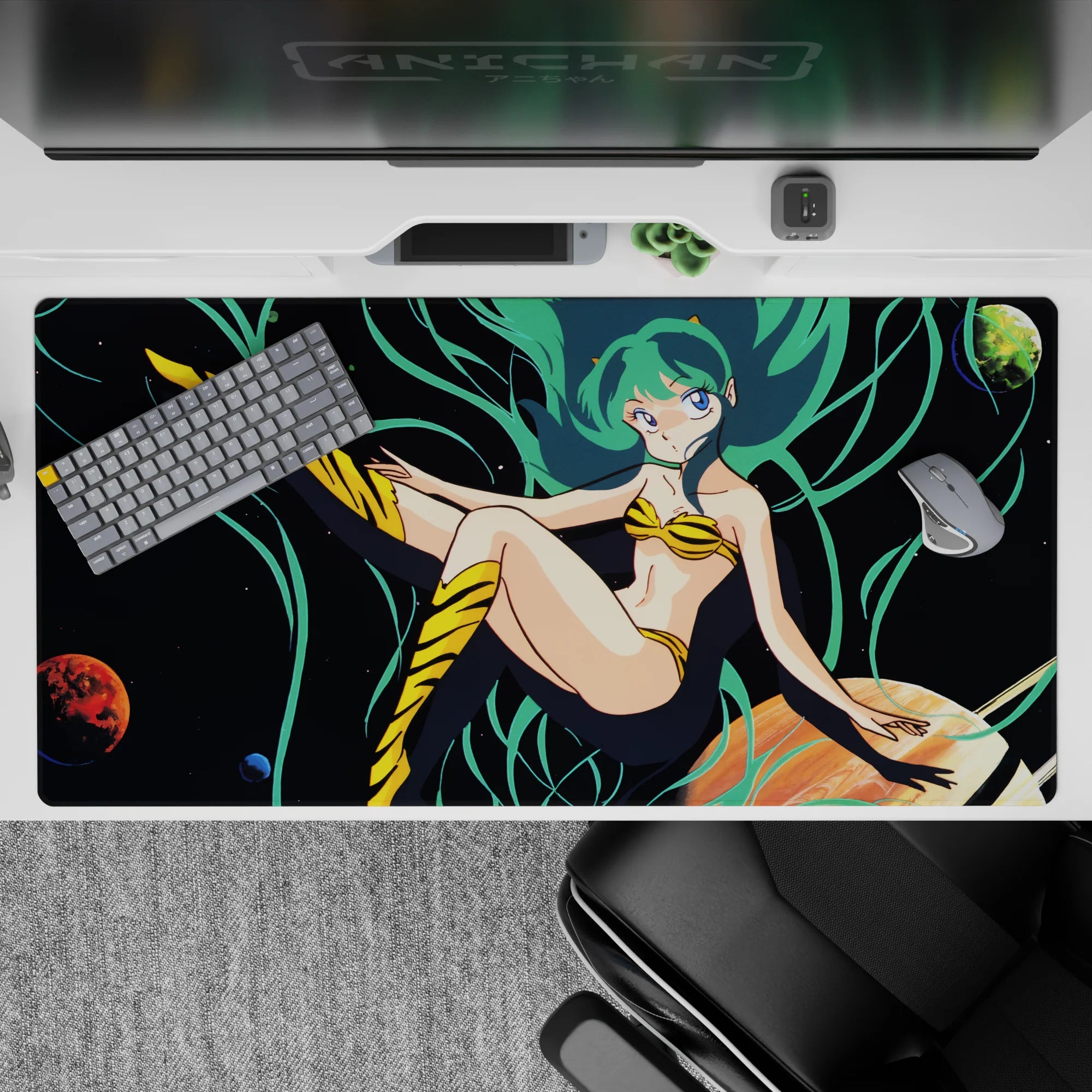 Neon teal and deep-space black 40x20 inches anime desk pad with playful cosmic vibe and smooth glide.
