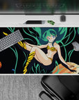 Neon teal and deep-space black 40x20 inches anime desk pad with playful cosmic vibe and smooth glide.