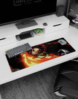 Tanjiro from Demon Slayer unleashes fiery sword arc on 32x12 inch anime mouse pad in vivid reds and golds against black.
