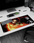 Tanjiro from Demon Slayer mid-swing with fiery blade design on a 36x16 inch anime mouse pad in red and gold tones.