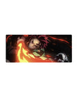 Anime mouse pad 28x12 inches featuring Tanjiro from Demon Slayer, sword mid-swing with fiery reds, golds, and embers.