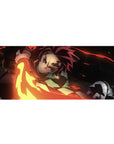 Tanjiro in action on a 36x16 inch anime desk pad, fiery sword swipe in reds, golds, against a black backdrop.