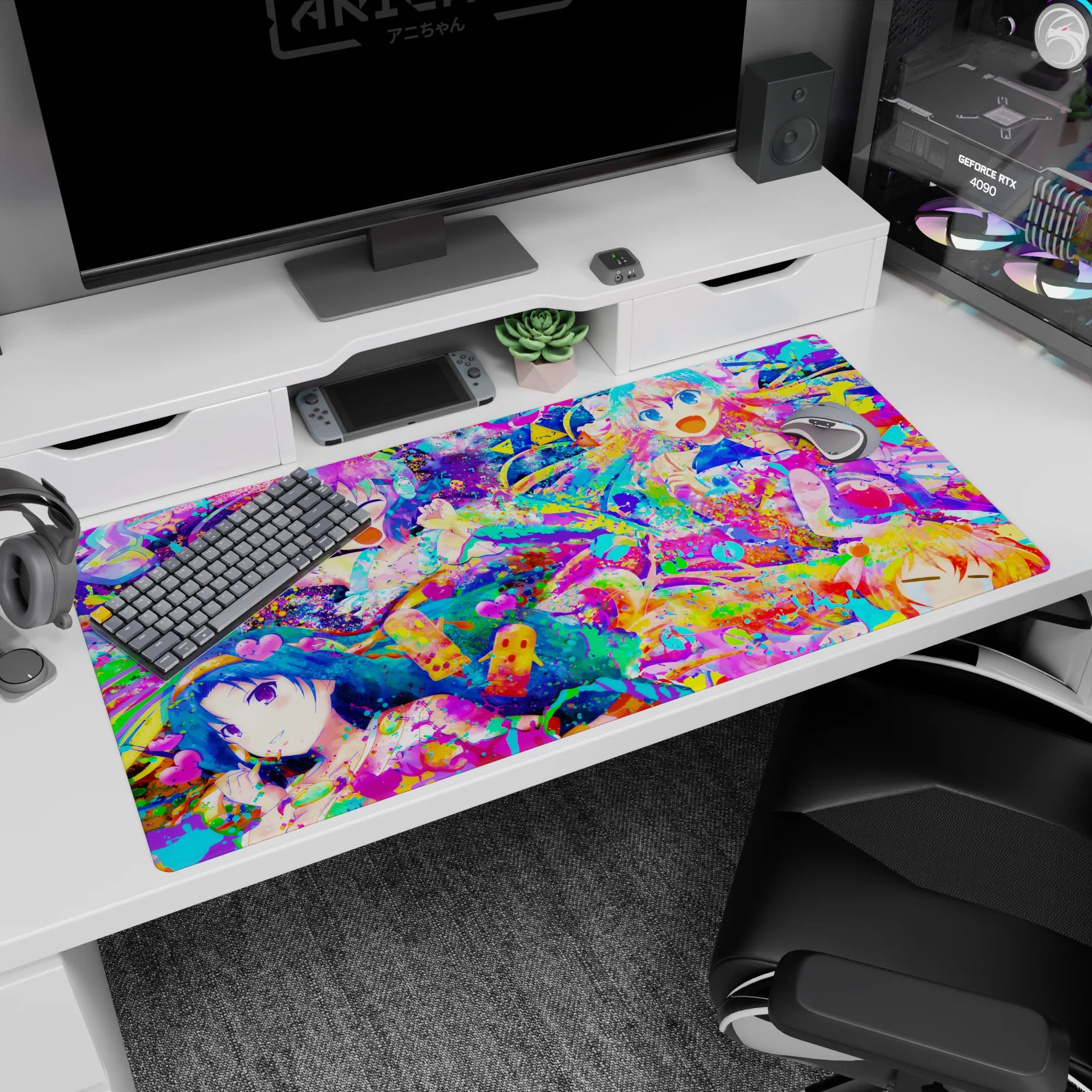 Four laughing anime girls amid bright paint bursts on extra large desk pad 40x20 inches, smooth glide.