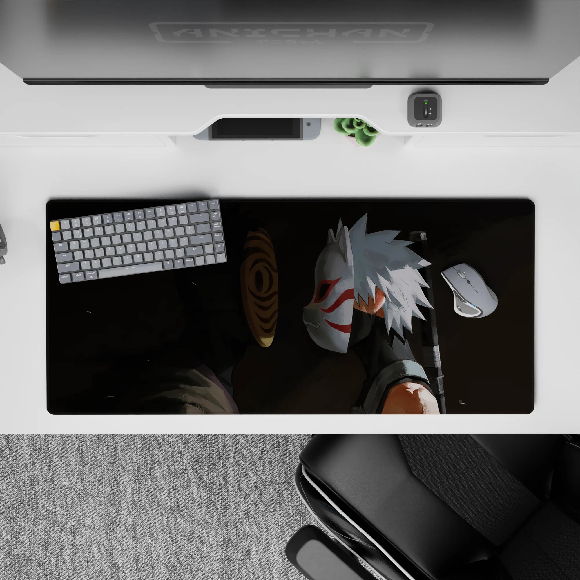 Dark charcoal swirl anime desk pad 36x16 inches with orange spiral mask, crisp whites, red accents.