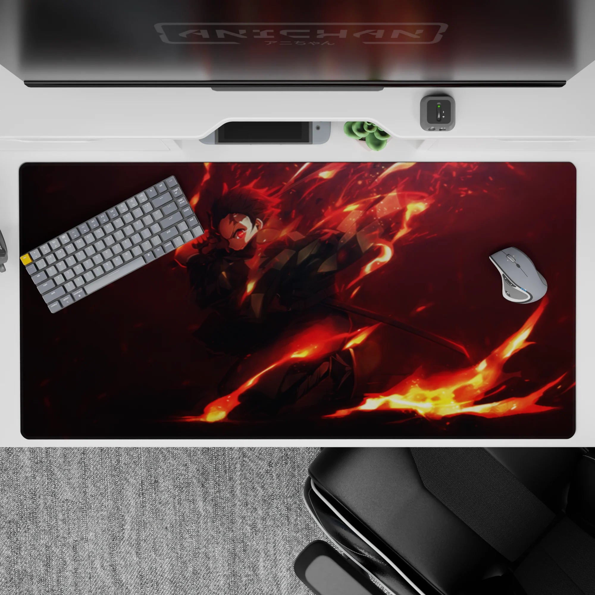 Anime desk pad 40x20 inches featuring Tanjiro charging through flames with glowing red eyes, vibrant blacks and oranges.