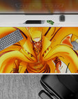 40x20 inches orange and gold fiery Naruto-themed desk pad, fast loud energy with glowing contrast.