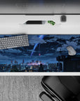 36x16 inches anime desk pad in neon blue and violet, dreamy skyline mood with deep navy shadows.