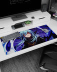 Sly blue-haired anime fighter in ink-black armor and fur collar on a 36x16 inches desk pad.