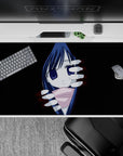 Spooky-cute 40x20 inches anime desk pad in deep black, midnight blue hair, indigo eyes, soft red glow.