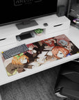 36x16 inches anime girl desk pad featuring a winking schoolgirl shushing, friends with glasses and green bow.