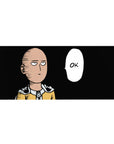 36x16 inches anime desk pad with Saitama on black background, yellow suit, cape clasp, OK speech bubble.