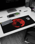 Silhouette swordsman under a huge crimson moon with birds in a starfield on an anime desk pad 36x16 inches.