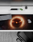 Cozy chaos desk pad 36x16 inches in warm orange glow, soft browns, and shadowy blacks.