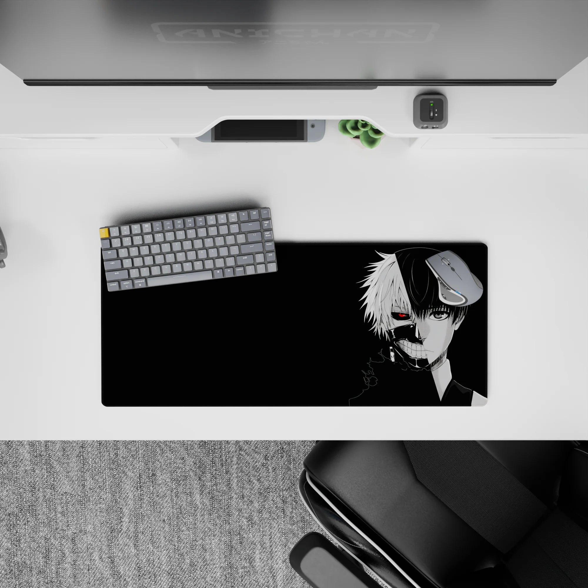 Kaneki&#39;s split face from Tokyo Ghoul on a 28x12 inch mouse pad, featuring a striking red eye against a black background.