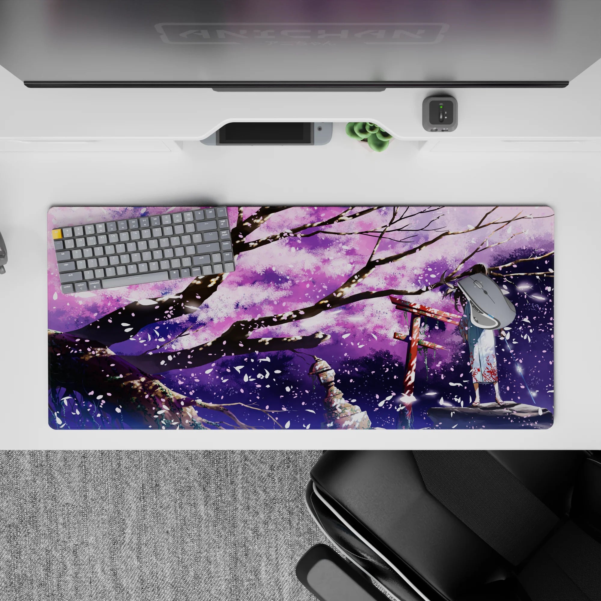 36x16 inches purple night desk pad in lilac clouds, black branches, and sparkling white sakura flakes.