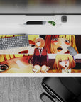 36x16 inches anime girl desk pad in warm gold and peach tones, cozy playful vibe with bold shadows.