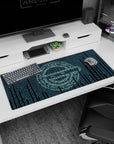 36x16 inches desk pad showing a quiet-eyed anime hacker face emerging from falling teal code glyphs.