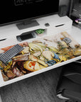 Natsu and Lucy in ruined stone scene anime desk pad 40x20 inches, scarf and blond ponytail, tender moment.