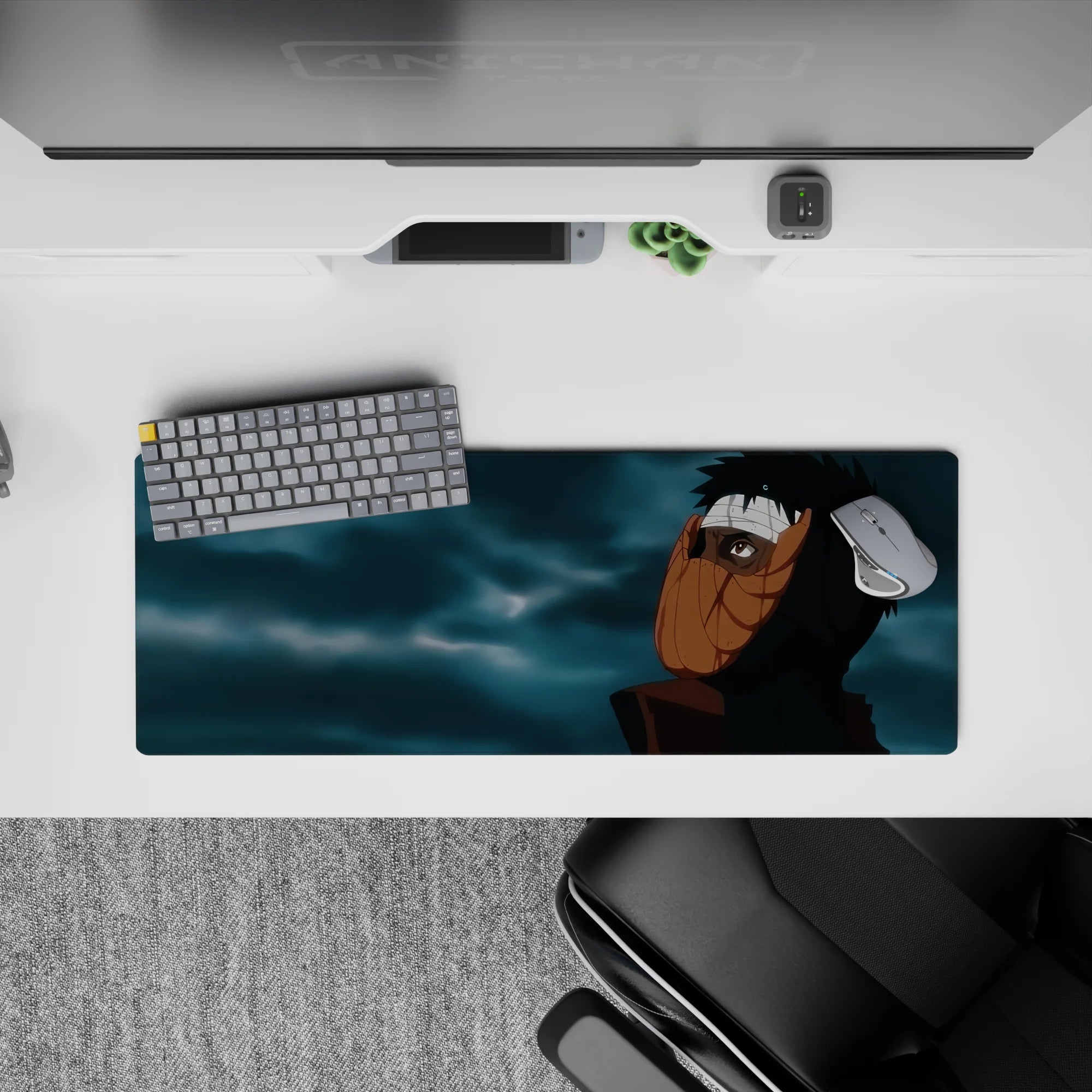 32x12 inches anime mouse pad in dark blacks with warm orange mask tones and moody blue-gray cloud swirls.