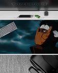 40x20 inches anime desk pad in dark blacks, warm orange mask tones, and moody blue-gray clouds.