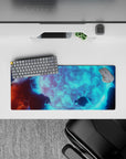 Cool aqua glow cosmic desk mat with deep shadows and floating rocks, 28x12 inches.