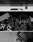 Anime desk pad 40x20 inches featuring monochrome chibi characters from Demon Slayer, offering bold black-and-white contrasts.